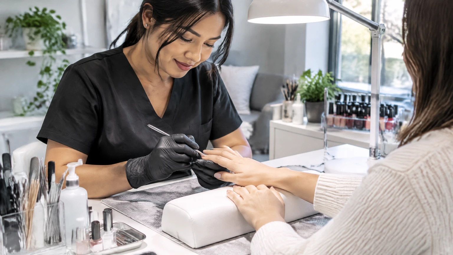 Nail technician at a manicure table during Stage 1 practice